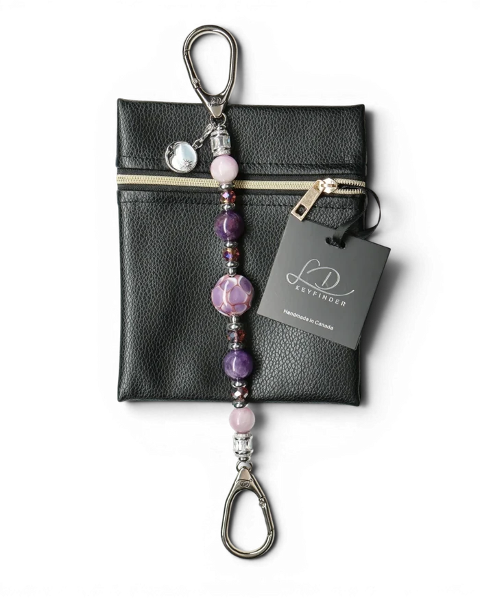 LD Keyfinder Amethyst Moon keychain with purple amethyst, pink kunzite, glass beads, and moon charm on black pouch.