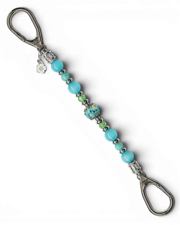 LD Keyfinder Azure Meadow keychain with aqua blue Amazonite, cat's eye beads, green glass beads, and a lampwork daisy bead.