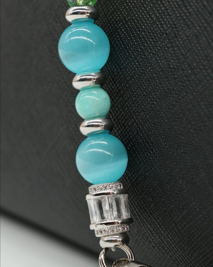 LD Keyfinder Azure Meadow lanyard with aqua blue cat's eye beads, Amazonite, green faceted glass, and rhinestone accents.