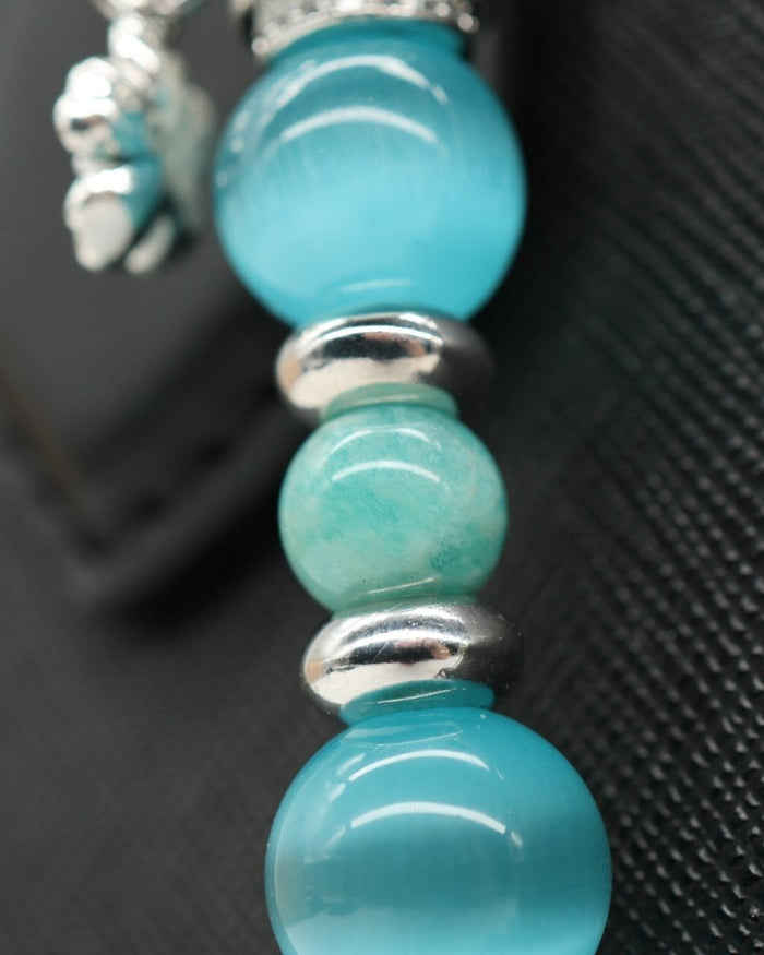LD Keyfinder Azure Meadow bracelet with aqua blue cat's eye beads, Amazonite, and silver daisy charm.