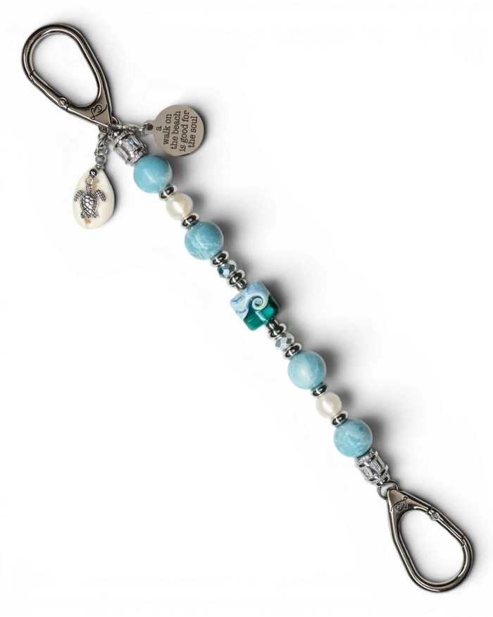 LD Keyfinder Beachy Dreams keychain with blue, teal, and white beads, freshwater pearls, a turtle charm, and a "A Walk on the Beach is Good for the Soul" charm.