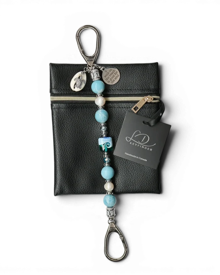 LD Keyfinder Beachy Dreams keychain with blue, teal, and white beads, freshwater pearls, a glass bead, turtle charm, and inspirational quote charm.