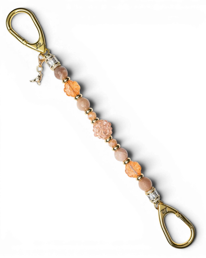 LD Keyfinder Birdsong Bliss beaded accessory with sunstone, coral flower beads, peach glass, and gold-plated bird charm.