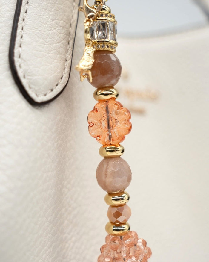 LD Keyfinder Birdsong Bliss beaded keychain with sunstone, coral flower beads, peach glass, and gold-plated bird charm.