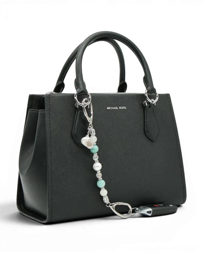 LD Keyfinder Caribbean Pearl beaded accessory featuring moonstone, aqua jade, and shell pearl attached to a black bag.