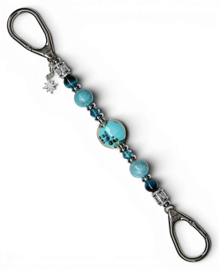 LD Keyfinder Celestial Tide keychain with turquoise glass bead, blue tiger eye, larimar, and silver accents, featuring a star charm.