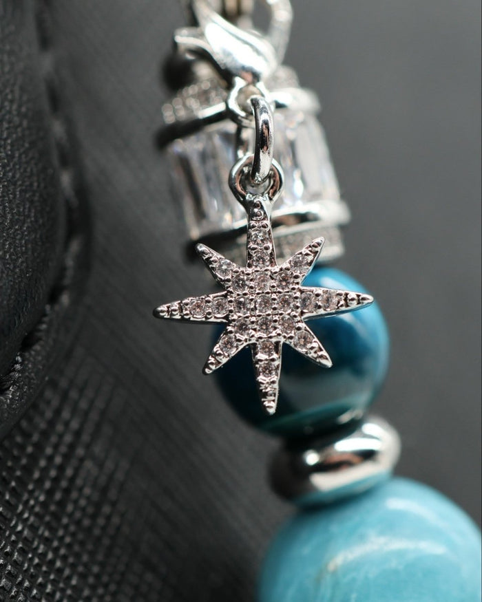 LD Keyfinder Celestial Tide bracelet with blue teal tiger eye, synthetic larimar beads, and a platinum-plated micropavé star charm.