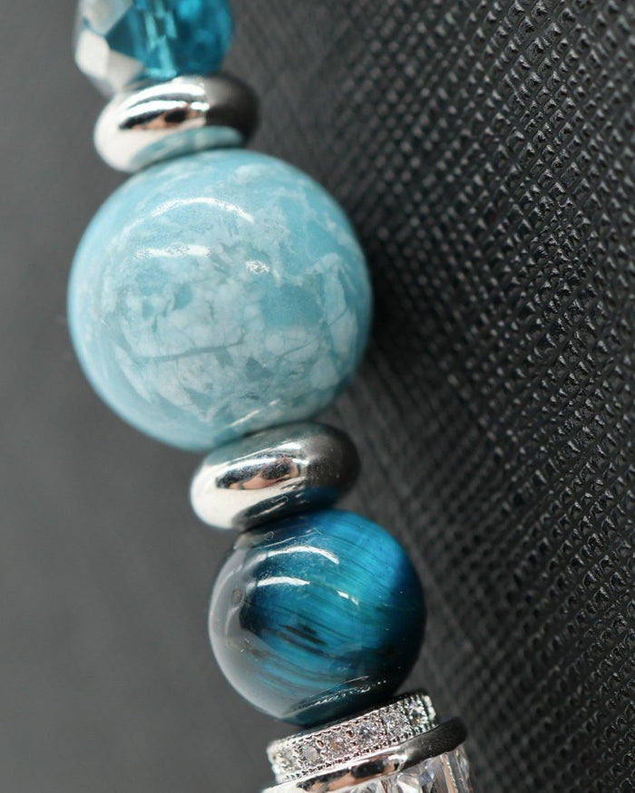 LD Keyfinder Celestial Tide bracelet with turquoise, aqua, blue tiger eye beads, silver spacers, and rhinestone accents.