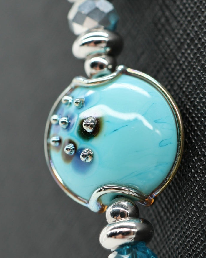 LD Keyfinder Celestial Tide bracelet with handcrafted turquoise glass bead, blue teal tiger eye, larimar, and silver accents.