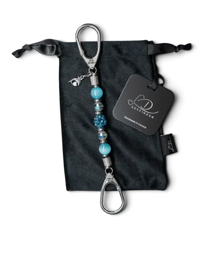 LD Keyfinder Dolphin Dream Mini beaded keychain with aqua glass beads and a rhinestone dolphin charm on a velvet bag