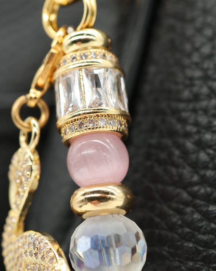 LD Keyfinder Flamingo Fantasy accessory featuring pink opal, cat's eye beads, crystal, and a gold flamingo charm.