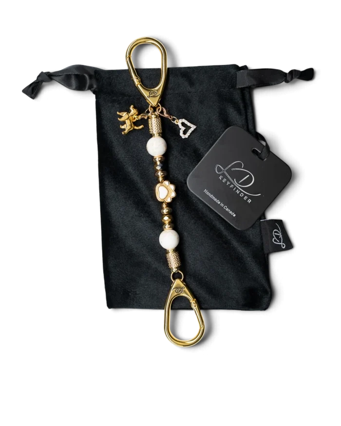 LD Keyfinder Furever Love-Mini keychain with white seashell beads, gold paw charm, and heart charm on velvet bag.
