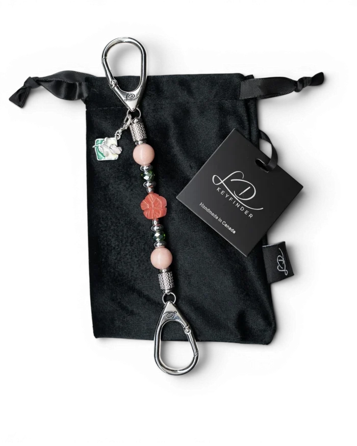 LD Keyfinder Garden Bliss-Mini featuring pink opal beads, cherry quartz flower, and enamel bouquet charm on velvet bag
