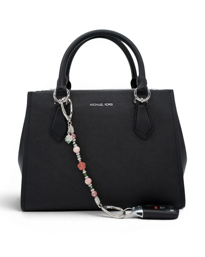 LD Keyfinder Garden Bliss beaded accessory with cherry quartz and pink opal attached to a black handbag