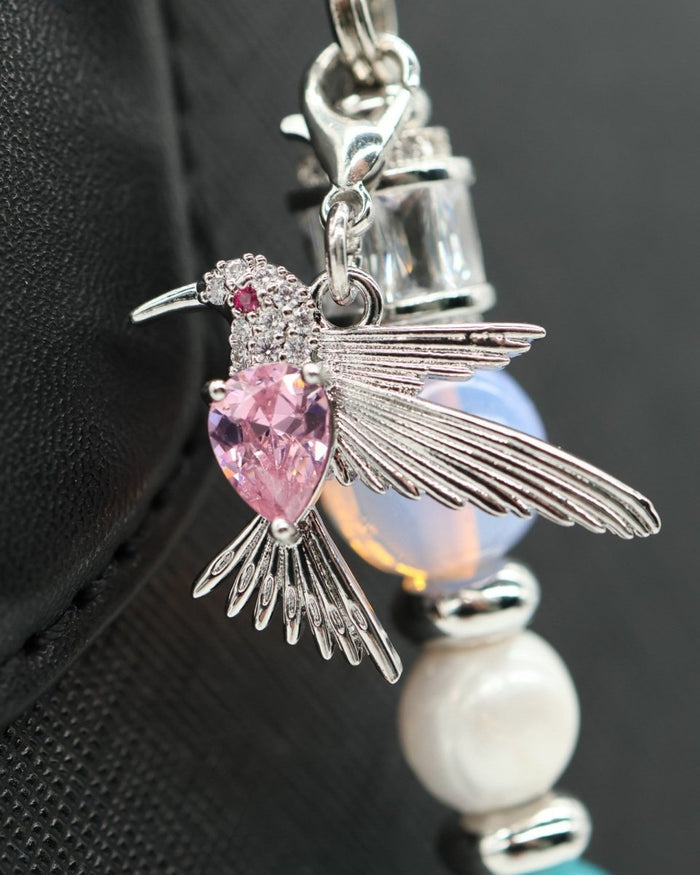 LD Keyfinder Garden Serenade accessory featuring a platinum-plated hummingbird charm with a pink crystal heart accent.