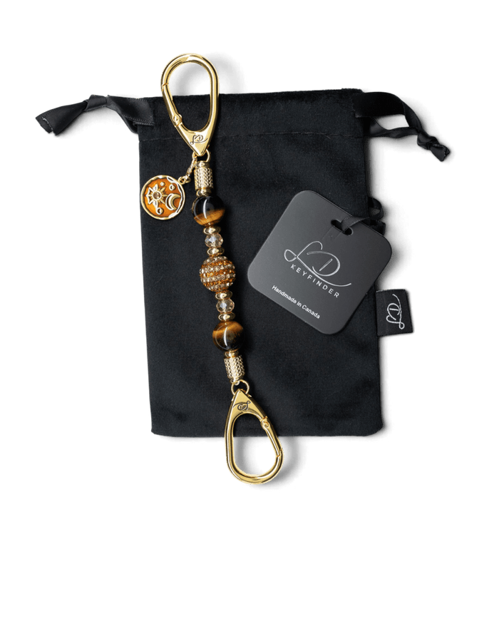 LD Keyfinder Golden Equinox-Mini with Tiger Eye beads, gold-plated sun and moon charm, and rhinestone centerpiece.