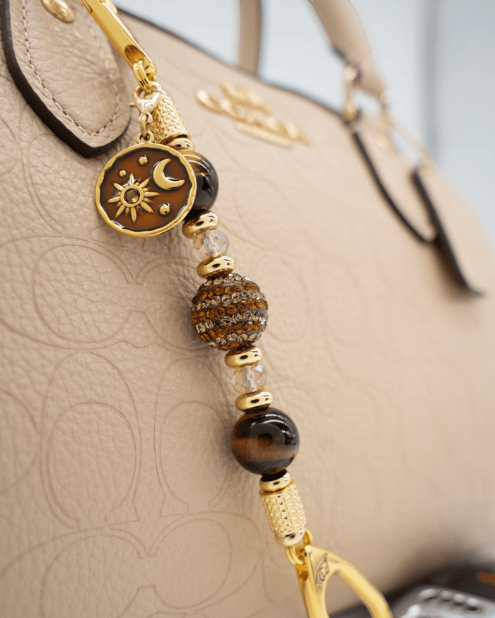 LD Keyfinder Golden Equinox-Mini featuring Tiger Eye beads, gold-plated sun and moon charm, and rhinestone centerpiece.