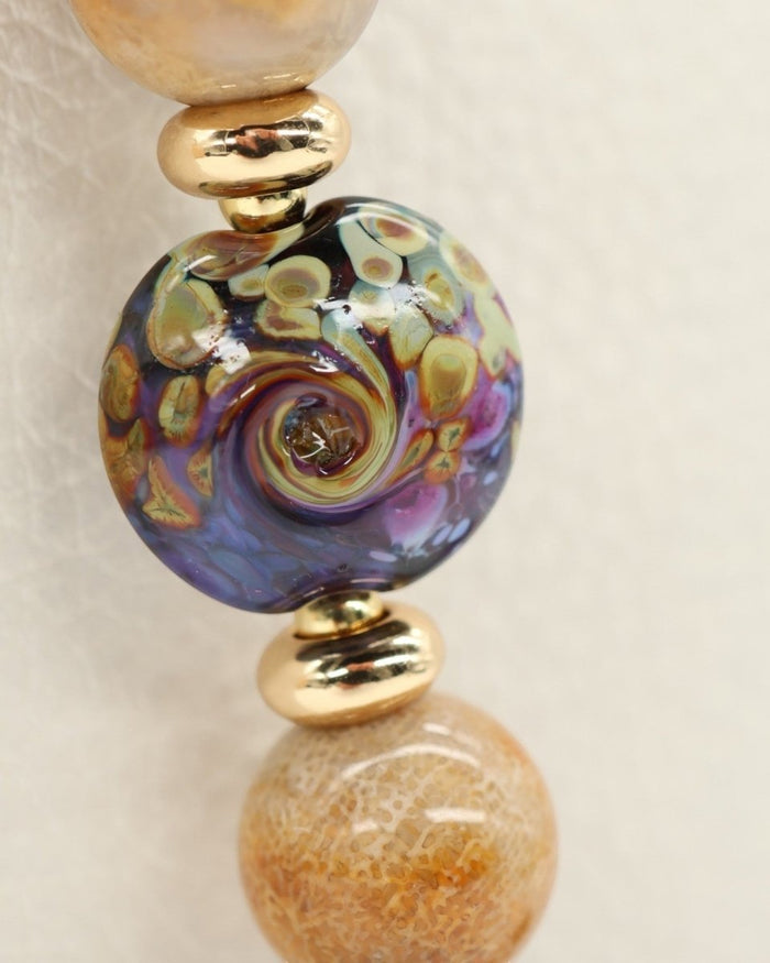 LD Keyfinder Golden Nebula bracelet with artisan glass bead, fossil coral, amethyst, and gold-plated accents.