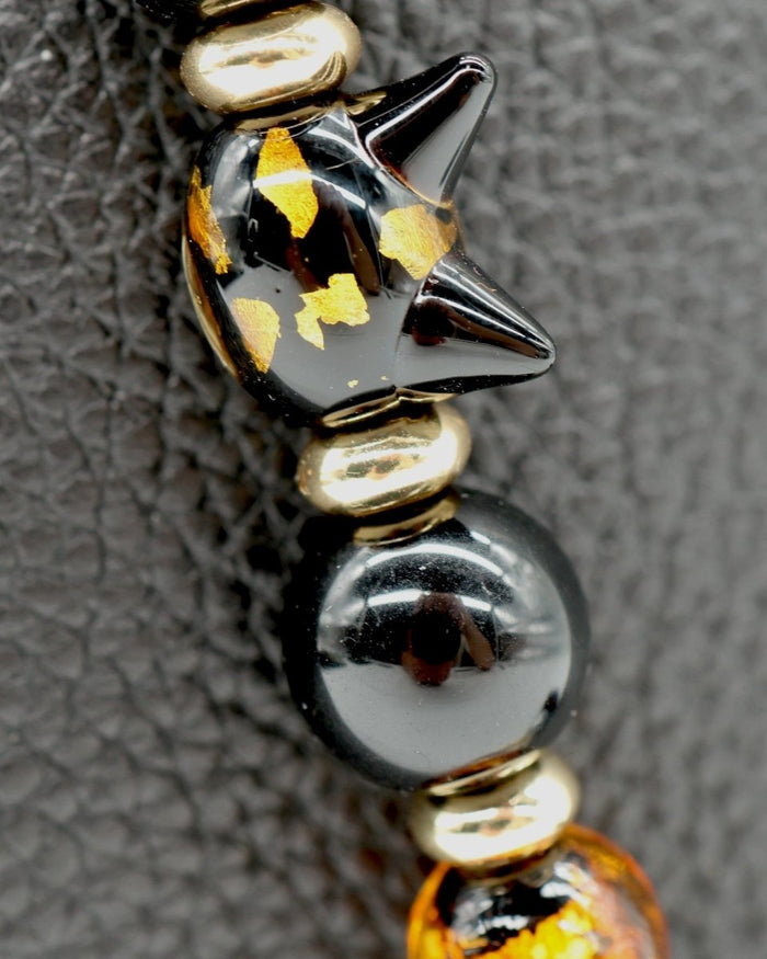 LD Keyfinder Golden Purrs beaded accessory featuring a black and gold foil cat head lampwork bead and obsidian beads.