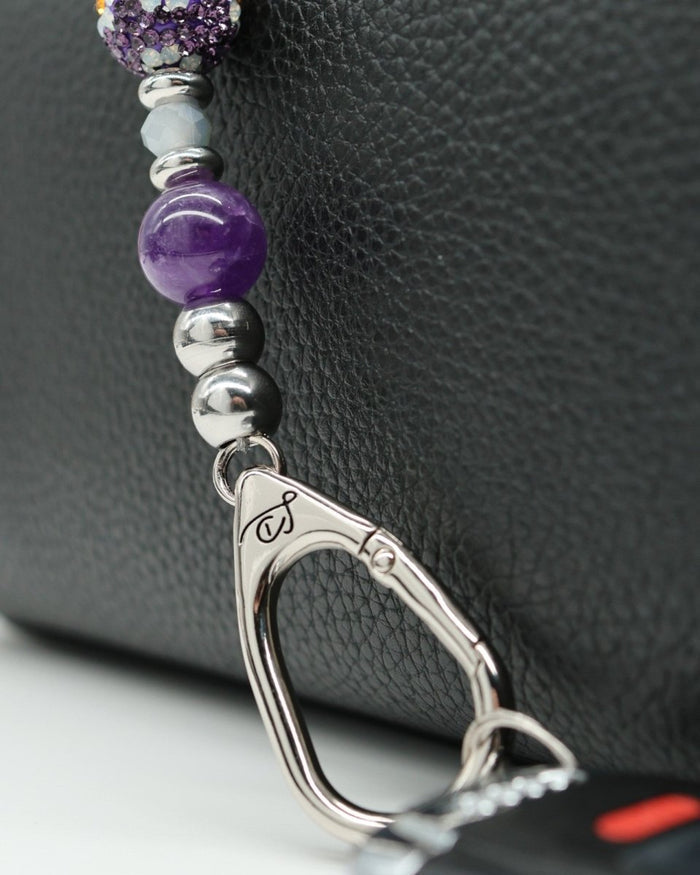 LD Keyfinder Hummingbird Dream Mini keychain with amethyst, crystal daisy bead, and silver charm attached to a car key.