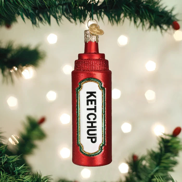 Ketchup bottle ornament hanging on a Christmas tree with lights in the background
