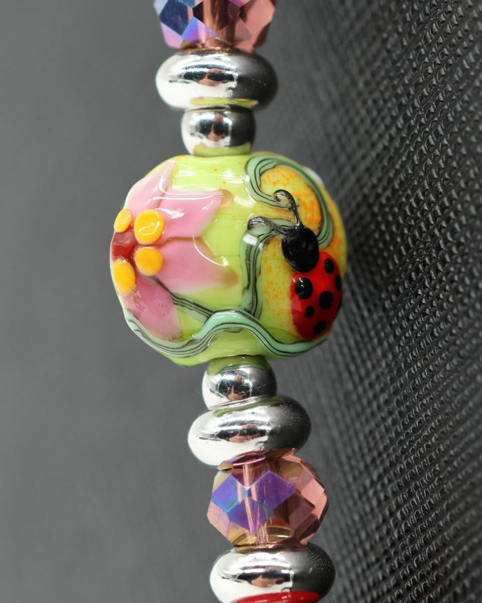 LD Keyfinder Ladybug Love beaded accessory featuring a handcrafted artisan glass bead with floral and ladybug design.