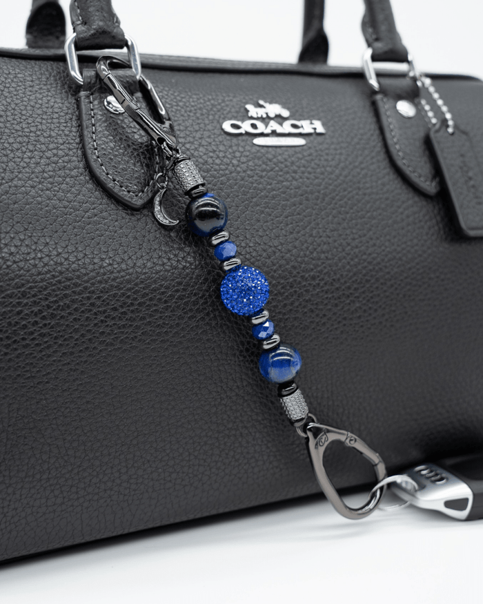 LD Keyfinder Midnight Sapphire Mini beaded keychain with blue tiger eye, sapphire crystals, and a moon charm on a bag