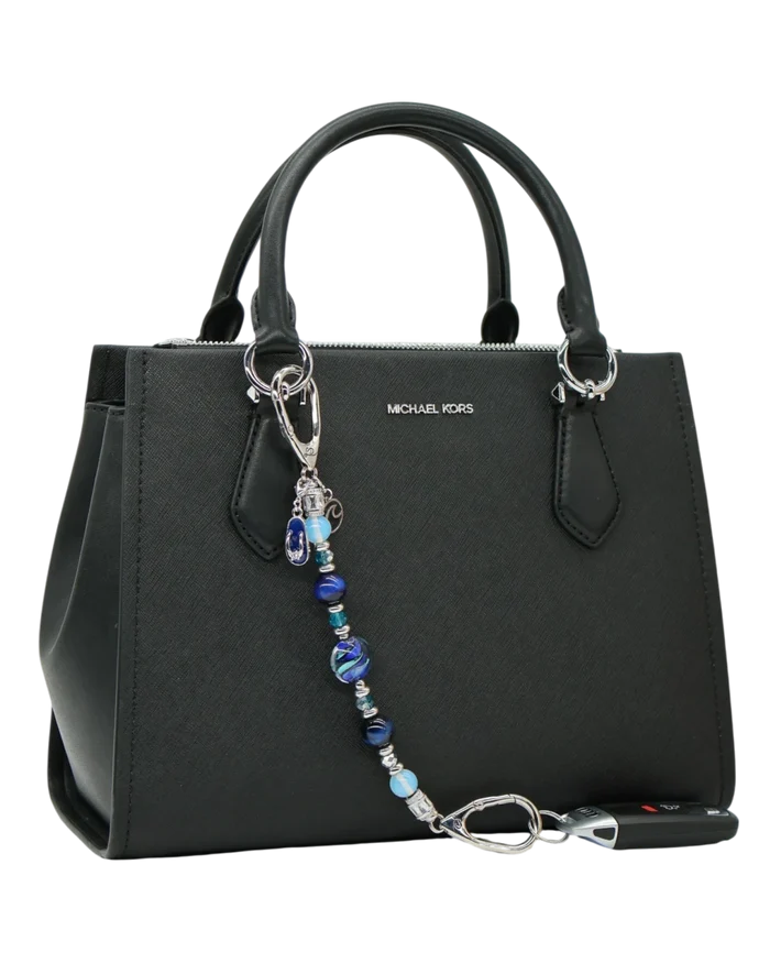 LD Keyfinder Ocean Mosaic beaded accessory with artisan glass, tiger eye, and charms attached to a black handbag