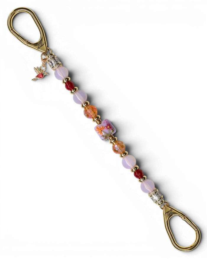 LD Keyfinder Opalite Bloom keychain with pink opalite, ruby, and orange glass beads, a floral lampwork bead, and a gold hummingbird charm.