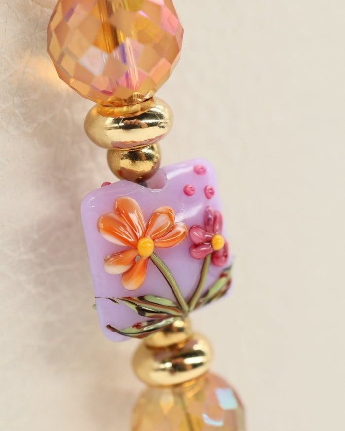 LD Keyfinder Opalite Bloom bracelet with lampwork glass bead featuring orange flowers on lilac, pink opalite, faceted ruby, and gold-plated beads.