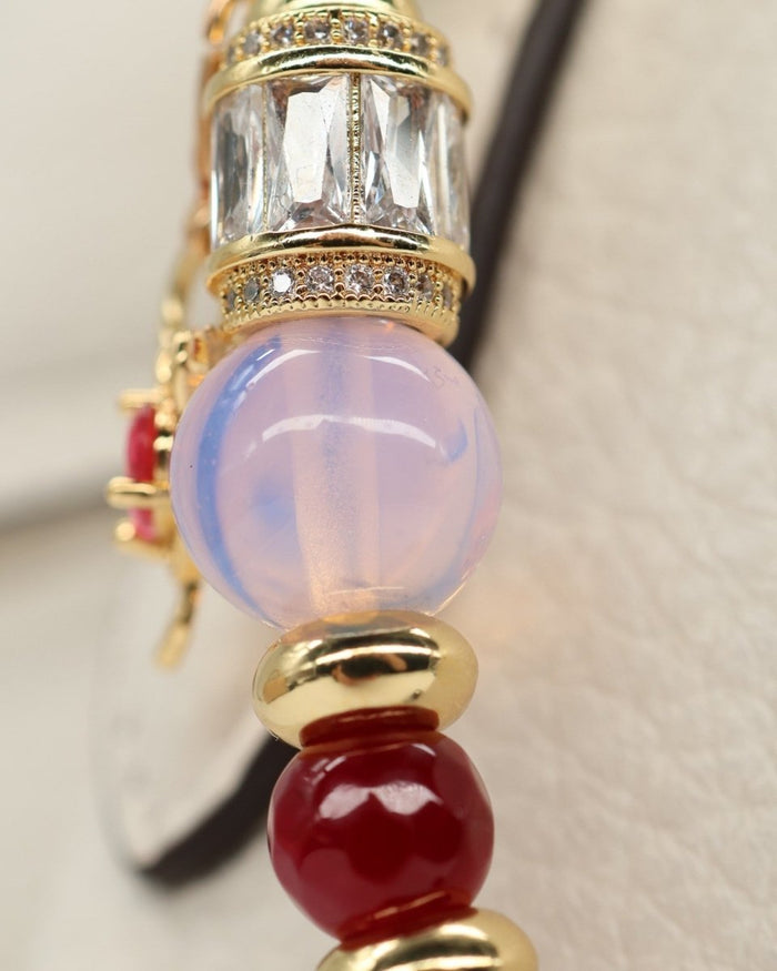 LD Keyfinder Opalite Bloom charm with pink opalite, ruby, and gold beads, and a crystal-encrusted barrel. Features a hummingbird charm.
