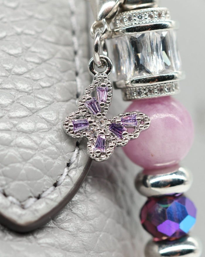 LD Keyfinder Orchid Flutter accessory featuring a purple rhinestone butterfly charm, lepidolite, and glass beads.