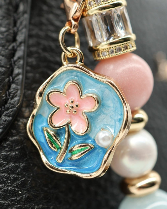 LD Keyfinder Pastel Garden charm with pink flower, blue enamel, pearls, aquamarine, and gold accents.
