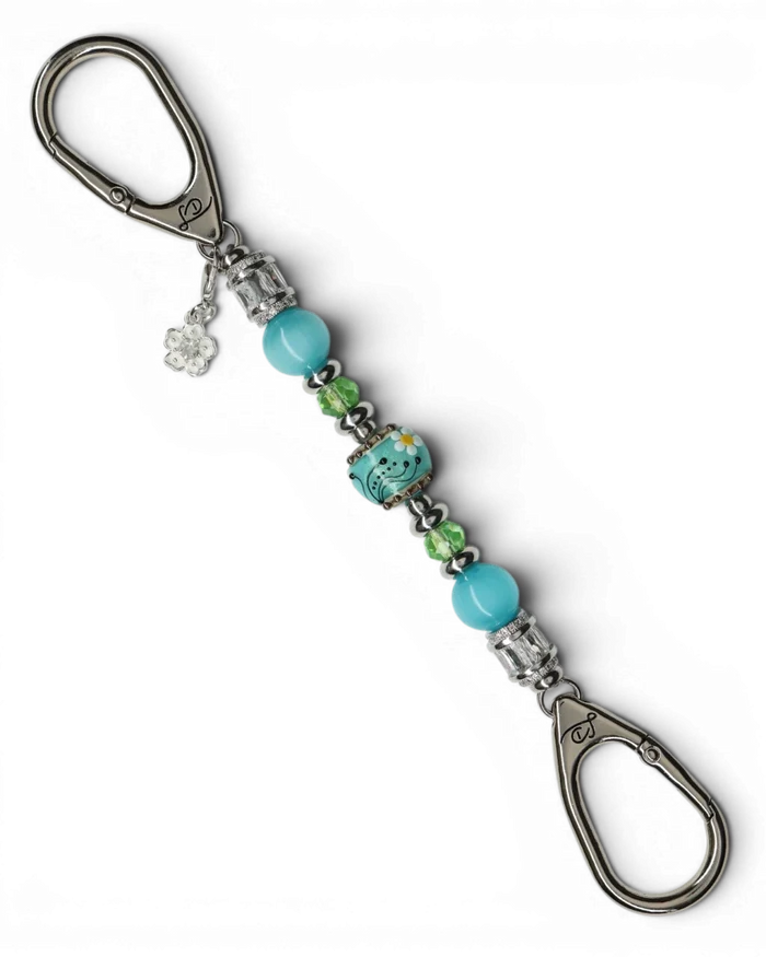 LD Keyfinder Petite Azure Meadow keychain with aqua blue cat's eye beads, green faceted glass beads, and a lampwork glass daisy bead.