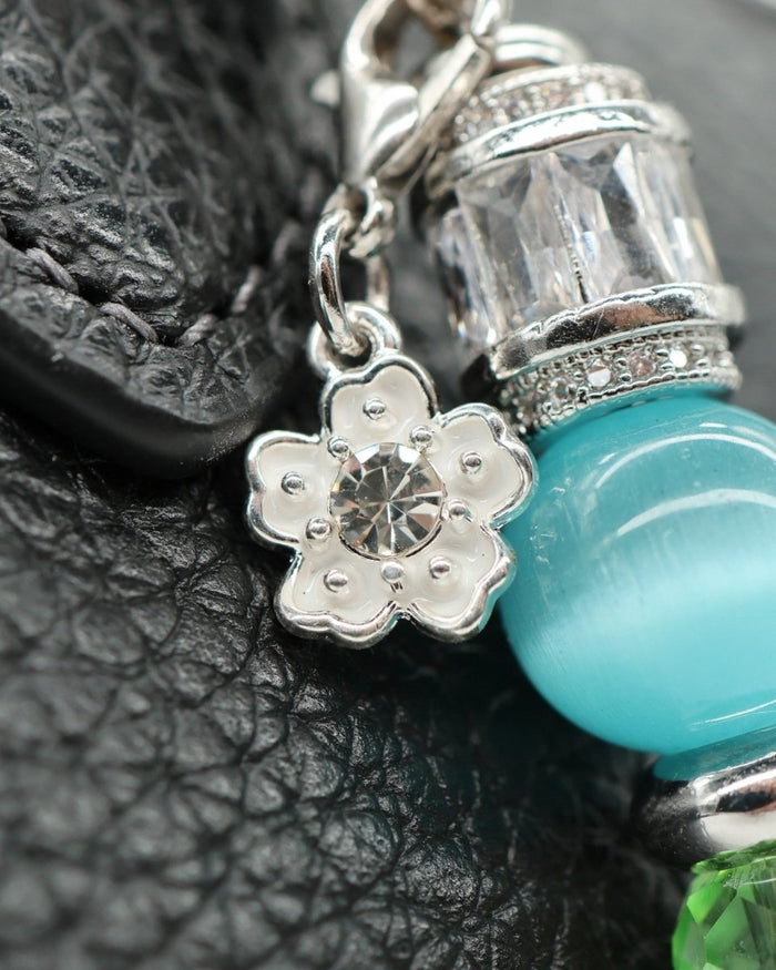 LD Keyfinder Petite Azure Meadow charm with white daisy, aqua cat's eye, and green faceted beads on platinum-plated chain.