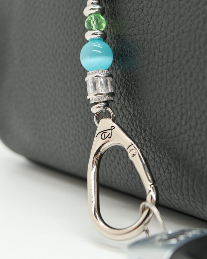 LD Keyfinder Petite Azure Meadow lanyard with aqua blue cat's eye beads, green glass beads, and a lampwork glass daisy bead.