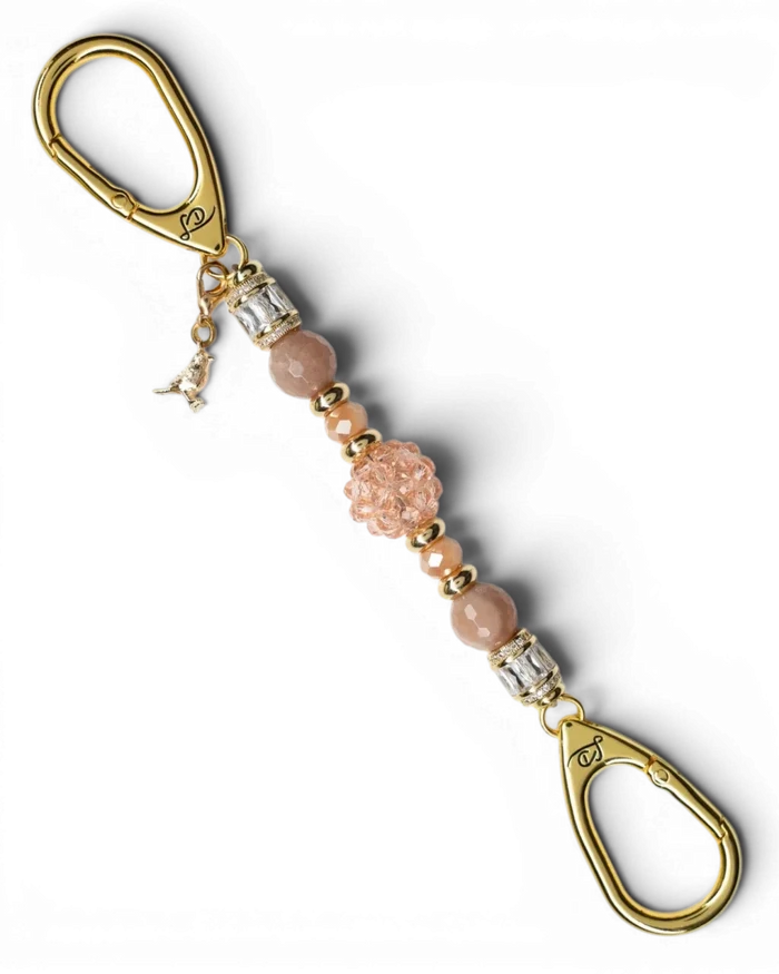 LD Keyfinder Petite Birdsong Bliss featuring peach glass, sunstone beads, and a gold-plated bird charm on a key clip.