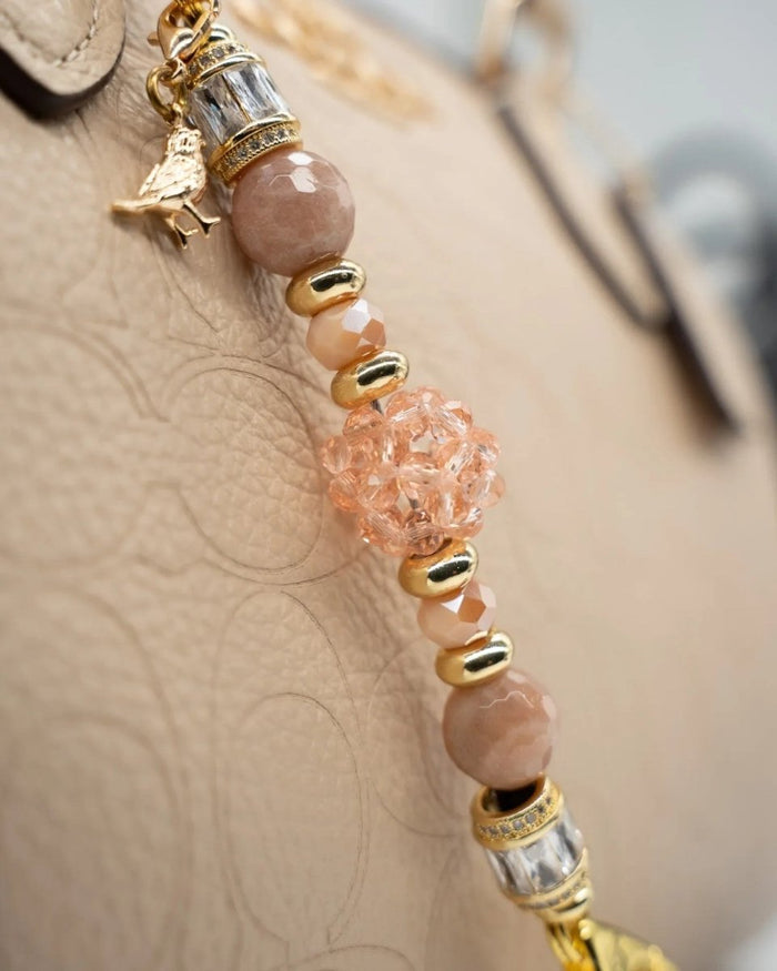LD Keyfinder Petite Birdsong Bliss featuring peach glass, faceted sunstone beads, and a gold-plated bird charm.