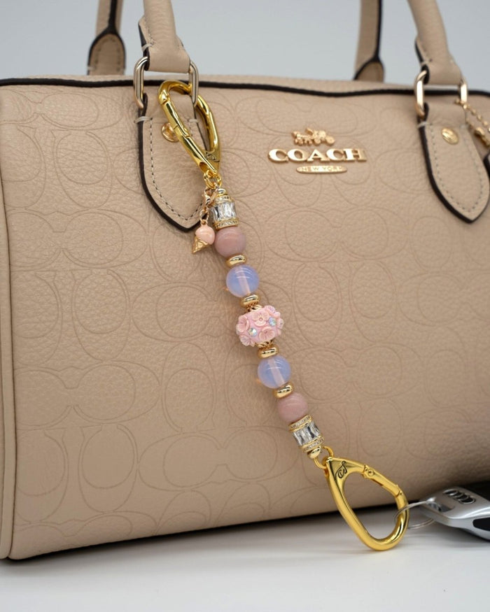LD Keyfinder Petite Blush Sorbetto featuring pink opal, opalite, floral bead, and gold ice cream charm on a handbag