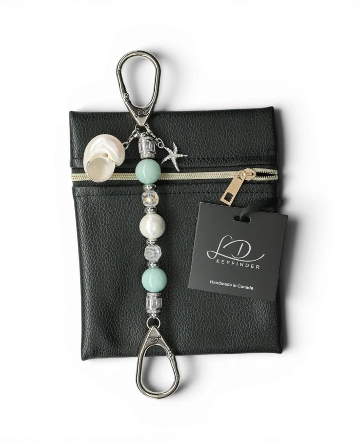 LD Keyfinder Petite Caribbean Pearl keychain with aqua jade, shell pearl, and starfish charm on a black leather bag.