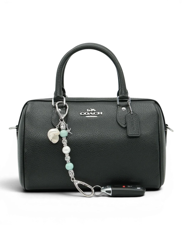 LD Keyfinder Petite Caribbean Pearl accessory with aqua jade, shell pearl, and starfish charm attached to a black bag