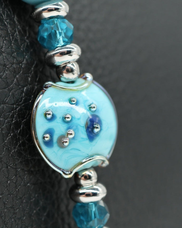LD Keyfinder Petite Celestial Tide bracelet with turquoise glass art bead, larimar, aqua, teal, and silver faceted beads, and platinum-plated star charm.