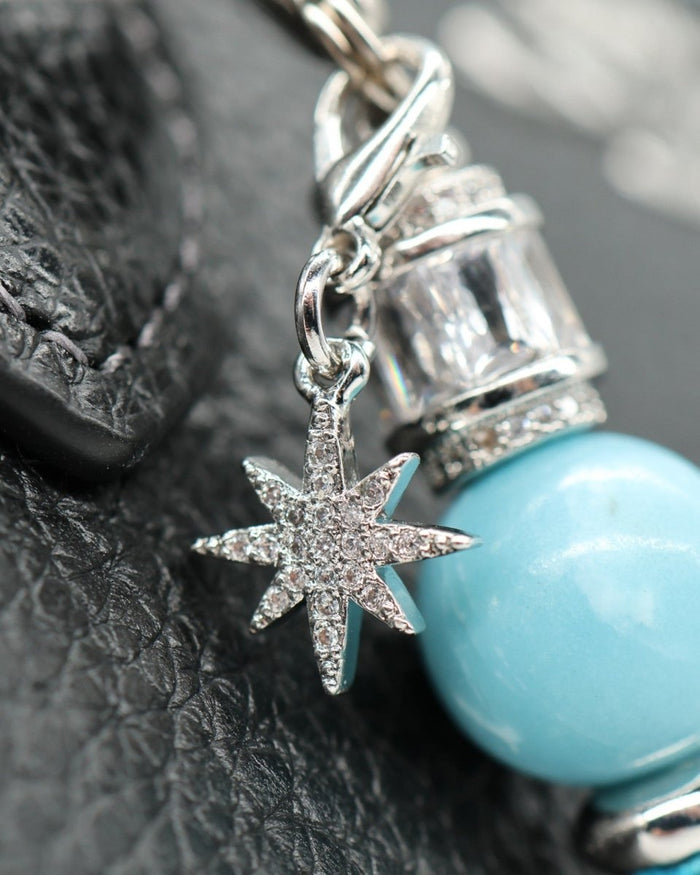LD Keyfinder Petite Celestial Tide bracelet with turquoise bead, star charm, and platinum accents.