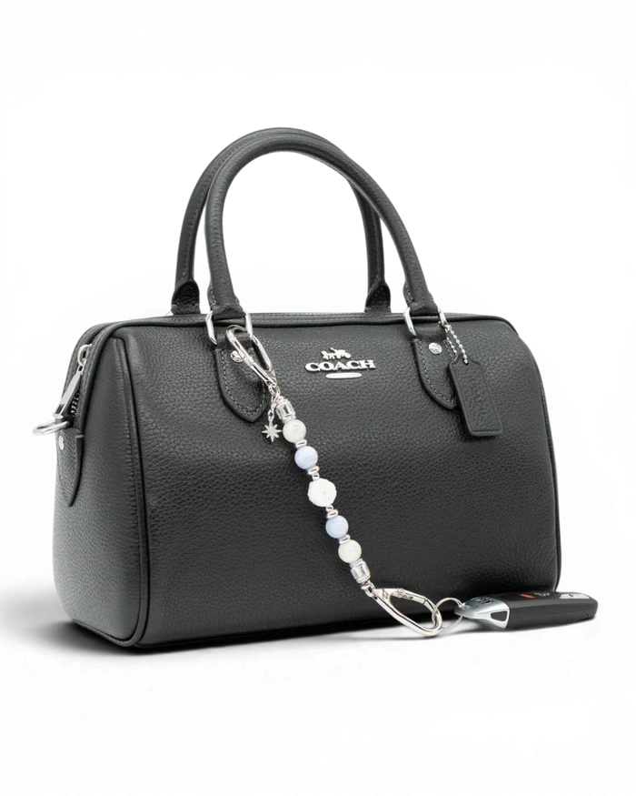 LD Keyfinder Petite Cloud Dancer beaded accessory with moonstone and blue lace agate attached to a black leather handbag