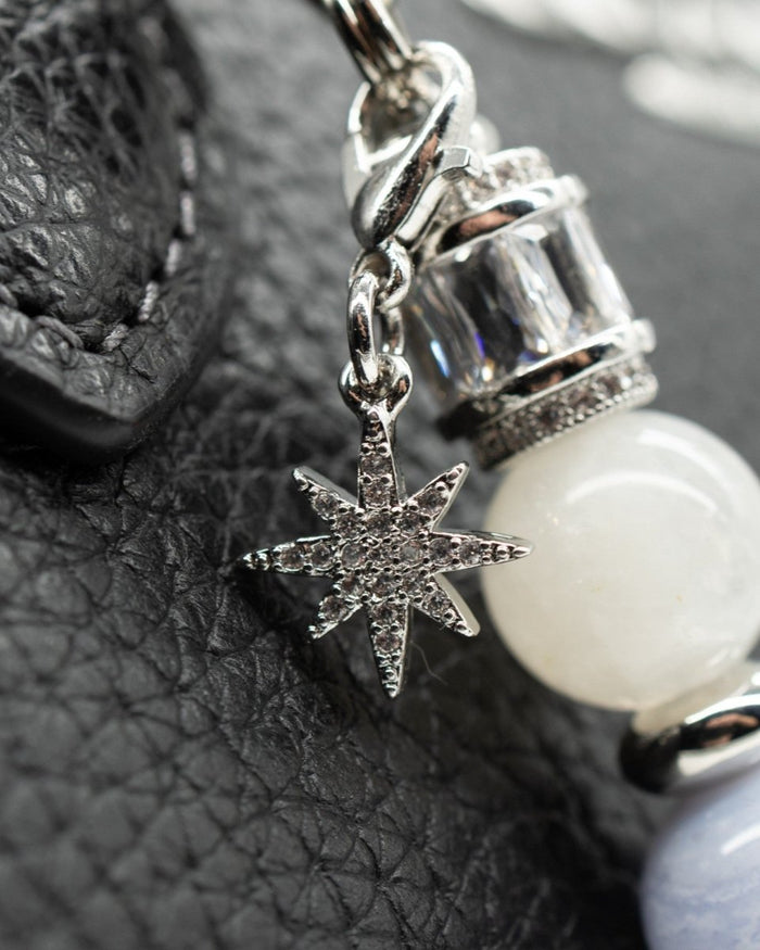 LD Keyfinder Petite Cloud Dancer charm with a pavé rhinestone star, baguette crystal, and moonstone on black leather