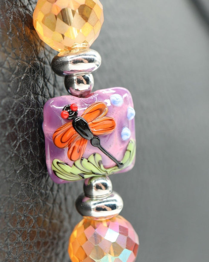LD Keyfinder Petite Dragonfly Magic bracelet with purple lepidolite, orange faceted glass, and lampwork dragonfly beads.