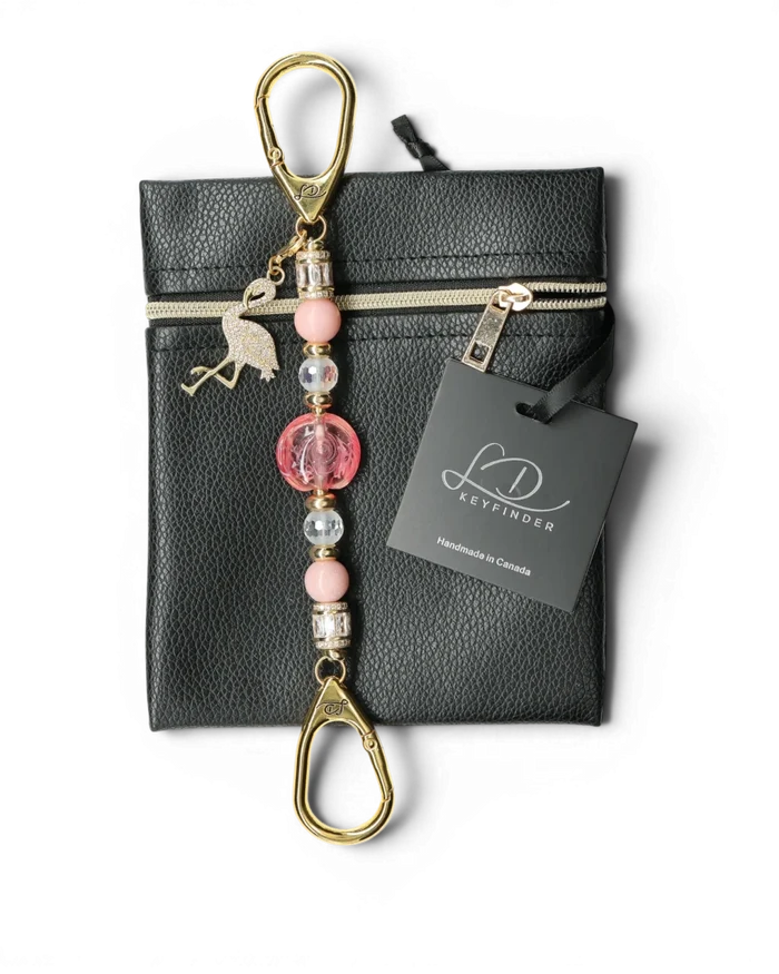 LD Keyfinder Petite Flamingo Fantasy keychain with pink opal, crystal beads, and gold flamingo charm on black pouch
