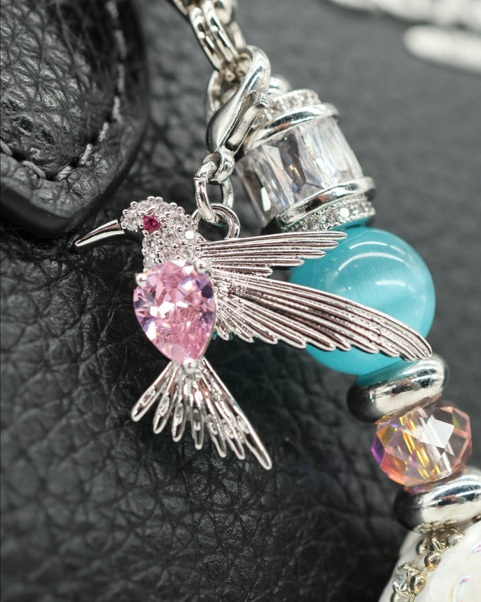 LD Keyfinder Petite Garden Serenade featuring a platinum-plated hummingbird charm with a pink crystal on a beaded chain