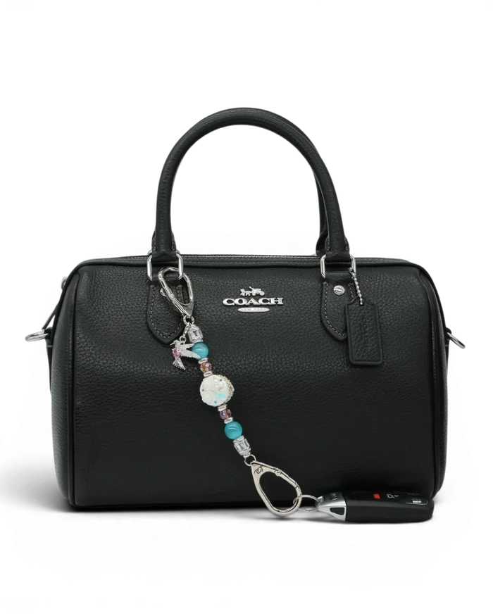 LD Keyfinder Petite Garden Serenade accessory with aqua and pink beads and hummingbird charm on a black handbag