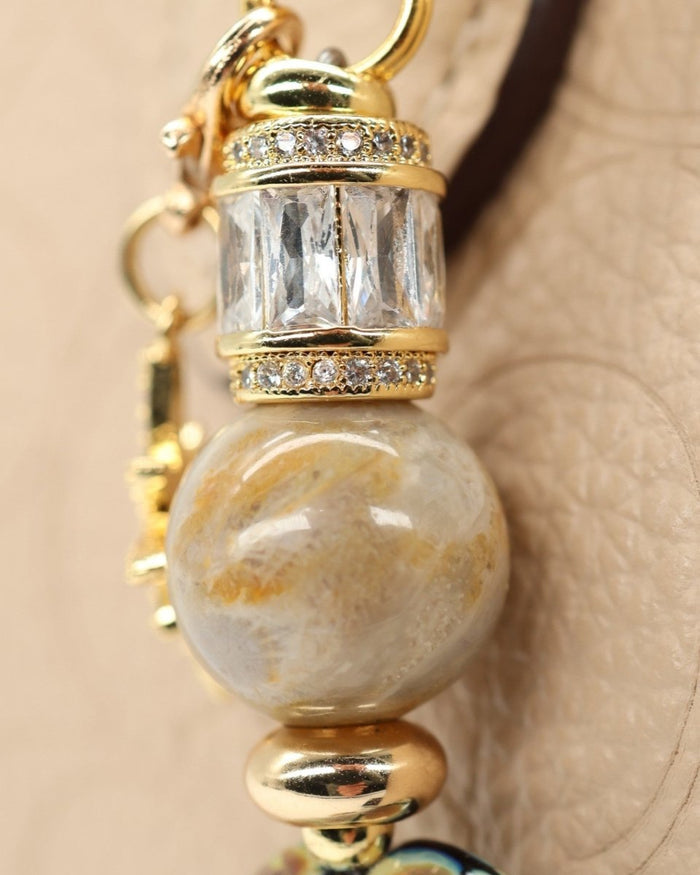 LD Keyfinder Petite Golden Nebula keyfinder with fossil coral bead, artisan glass bead, and gold-plated star charm.